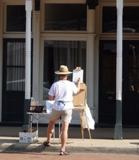 Belleville artist Brad Eilering at work on St. Louis Street in Lebanon on Saturday, Aug. 2, 2014. 
